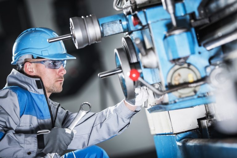 Metal Lathe Maintenance by Professional Caucasian Technician.